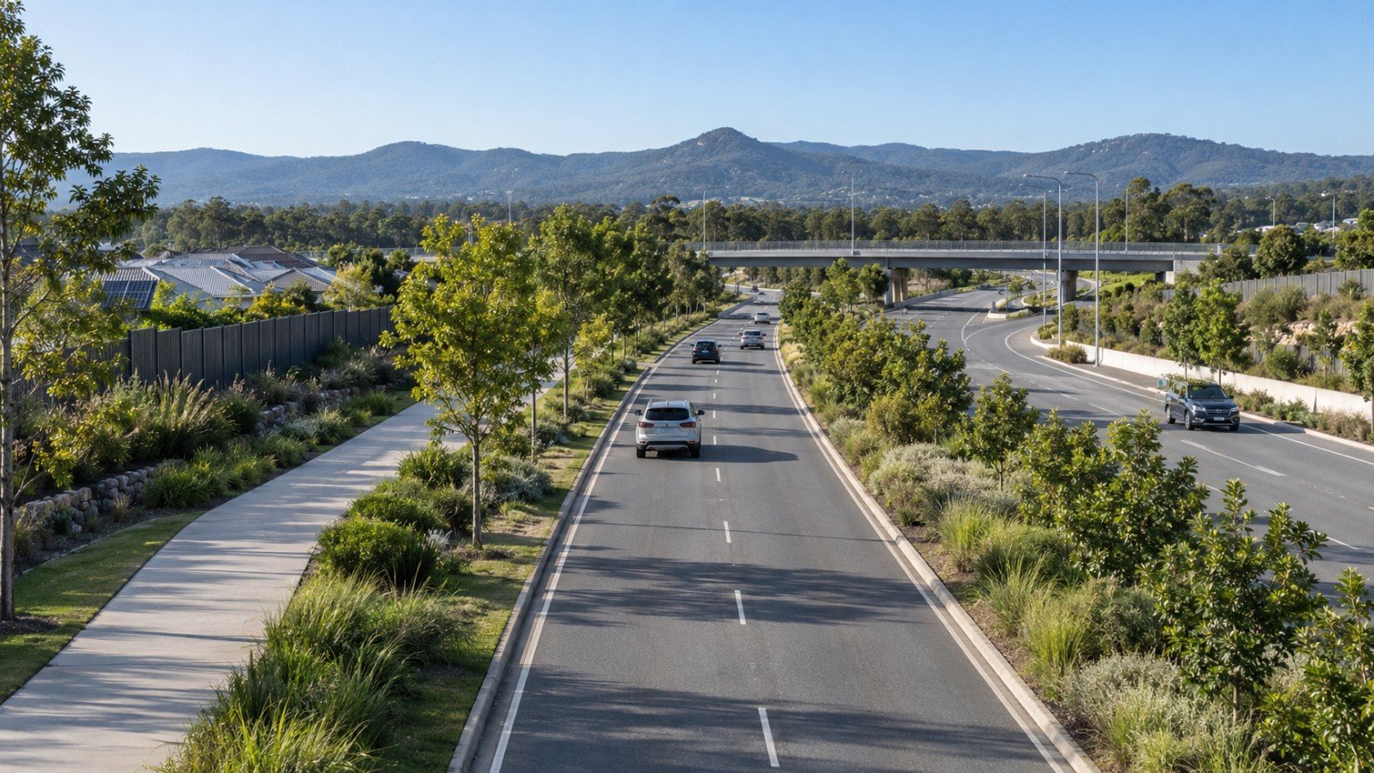 Landscaped boulevard and motorway access corridor serving a master-planned community west of Brisbane