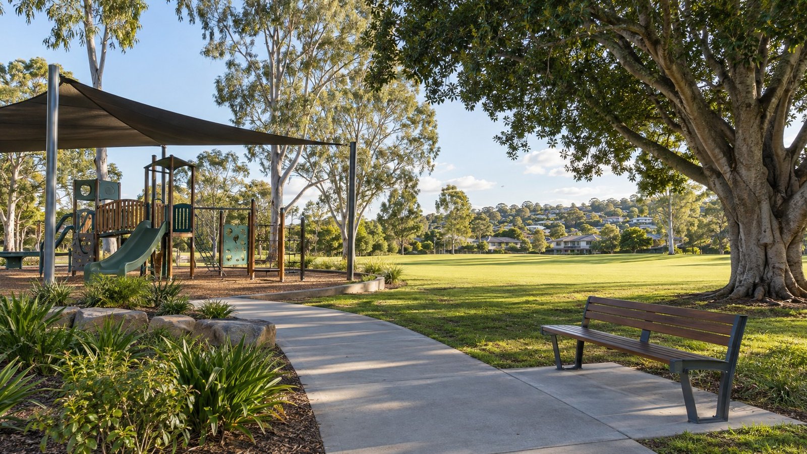 Established suburban park with playground equipment, shade trees and open lawn