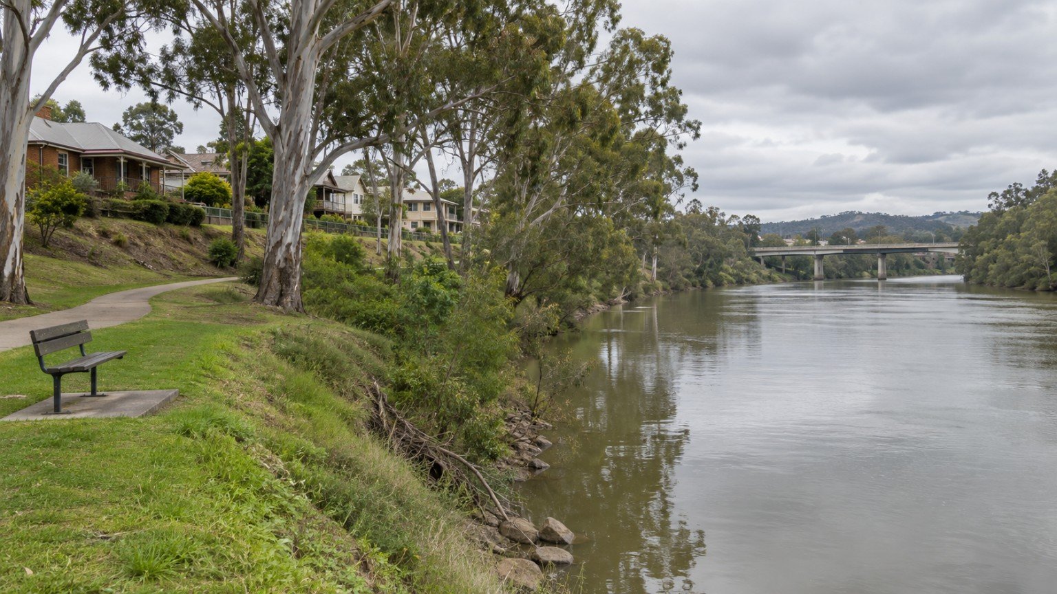 The Bremer River at Ipswich with homes and parkland on the elevated bank above