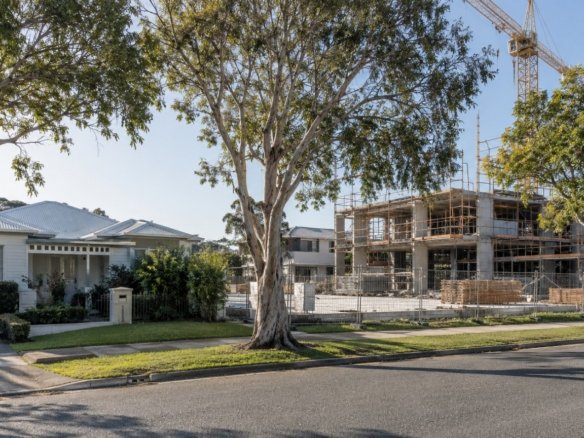 Established house beside a vacant site where a multi-unit building is under construction