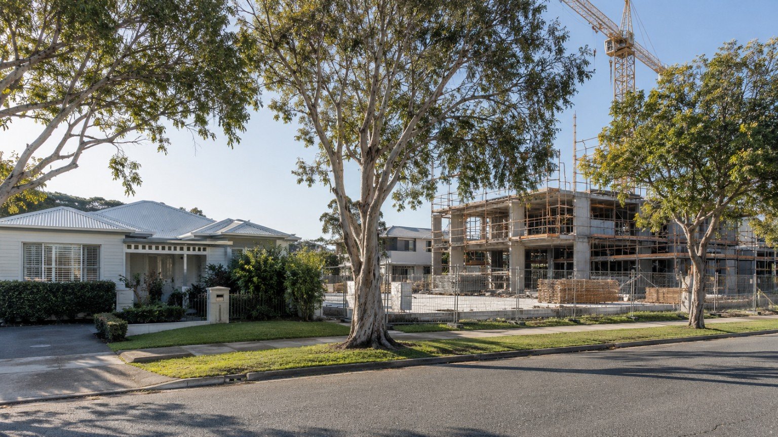 Established house beside a vacant site where a multi-unit building is under construction