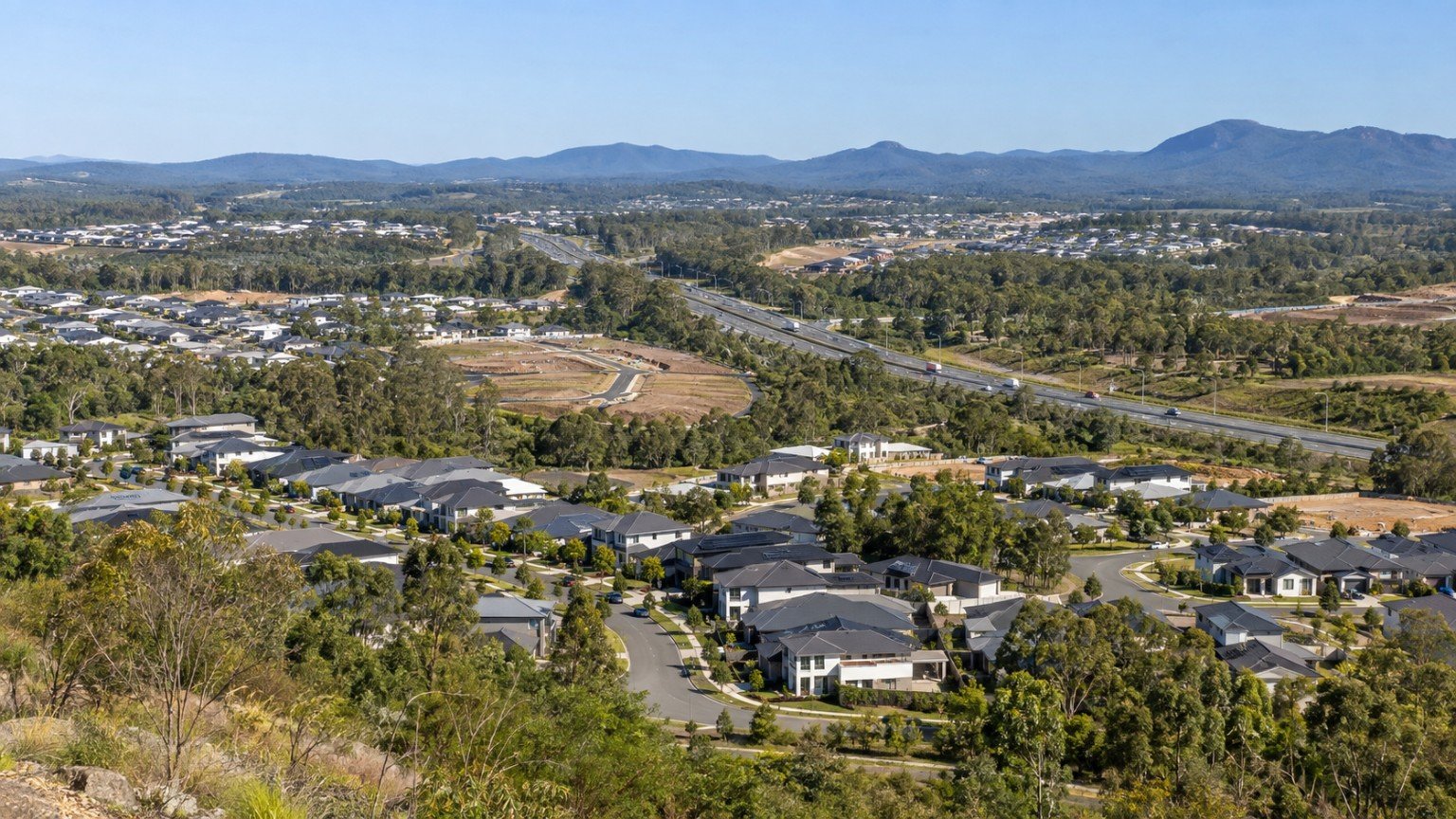 Northern Gold Coast growth corridor with residential estates, a motorway and bushland