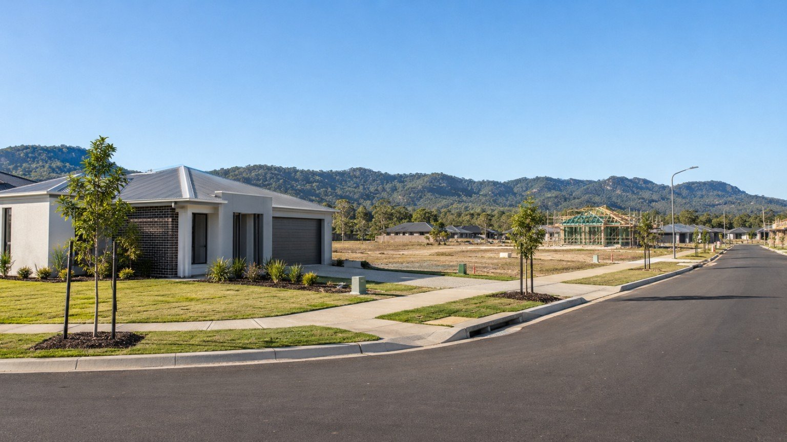New residential estate with recently completed homes beside vacant serviced lots