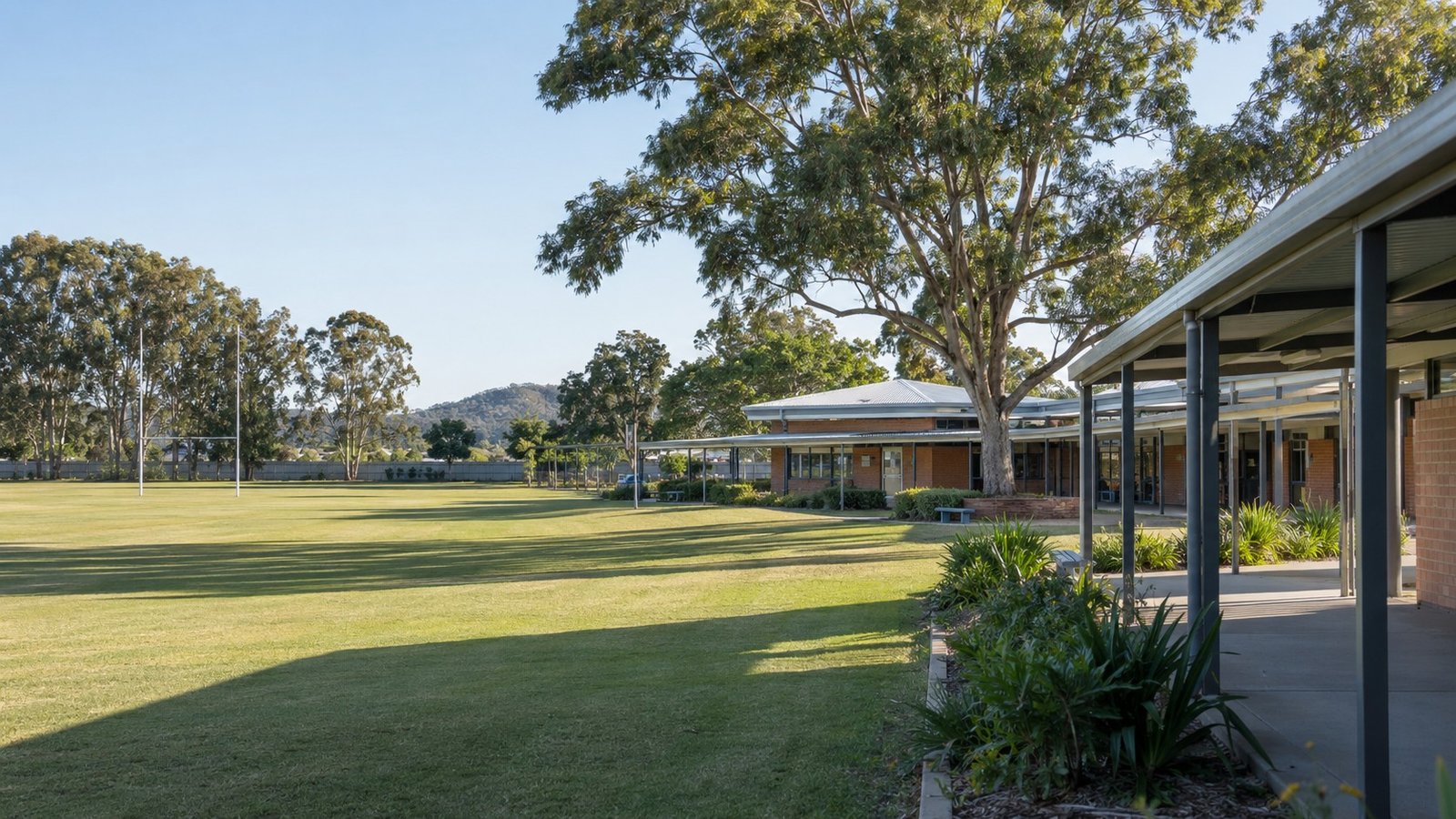 Established Queensland school buildings with covered walkway and sports oval