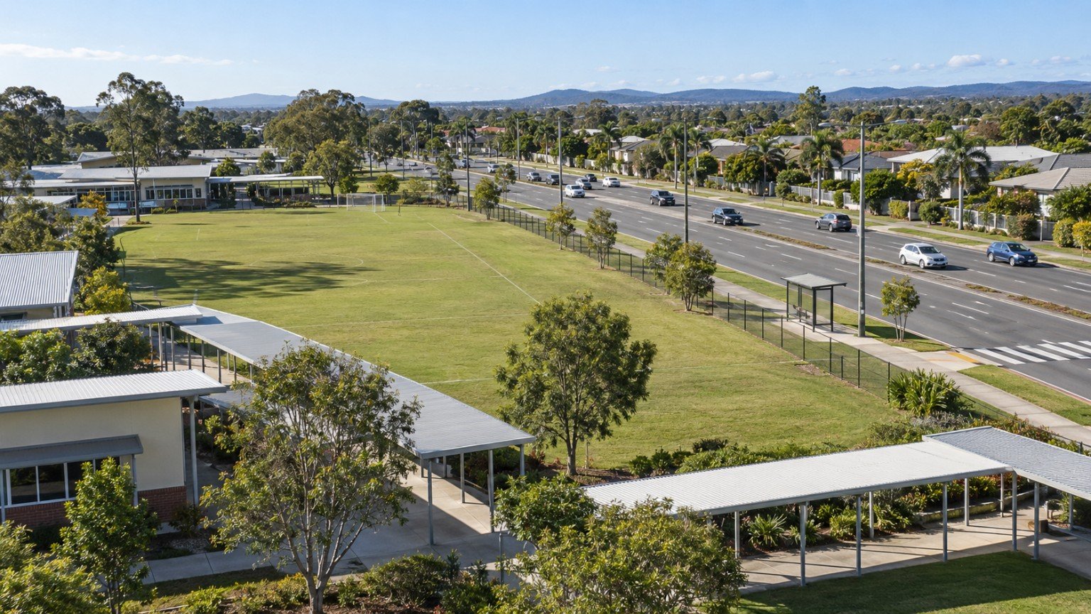 Queensland school grounds beside a main road corridor in a family suburb