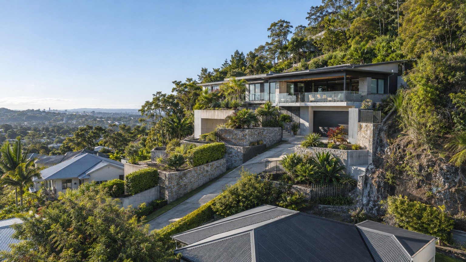Split-level Queensland home built into a steep residential block with tiered retaining walls