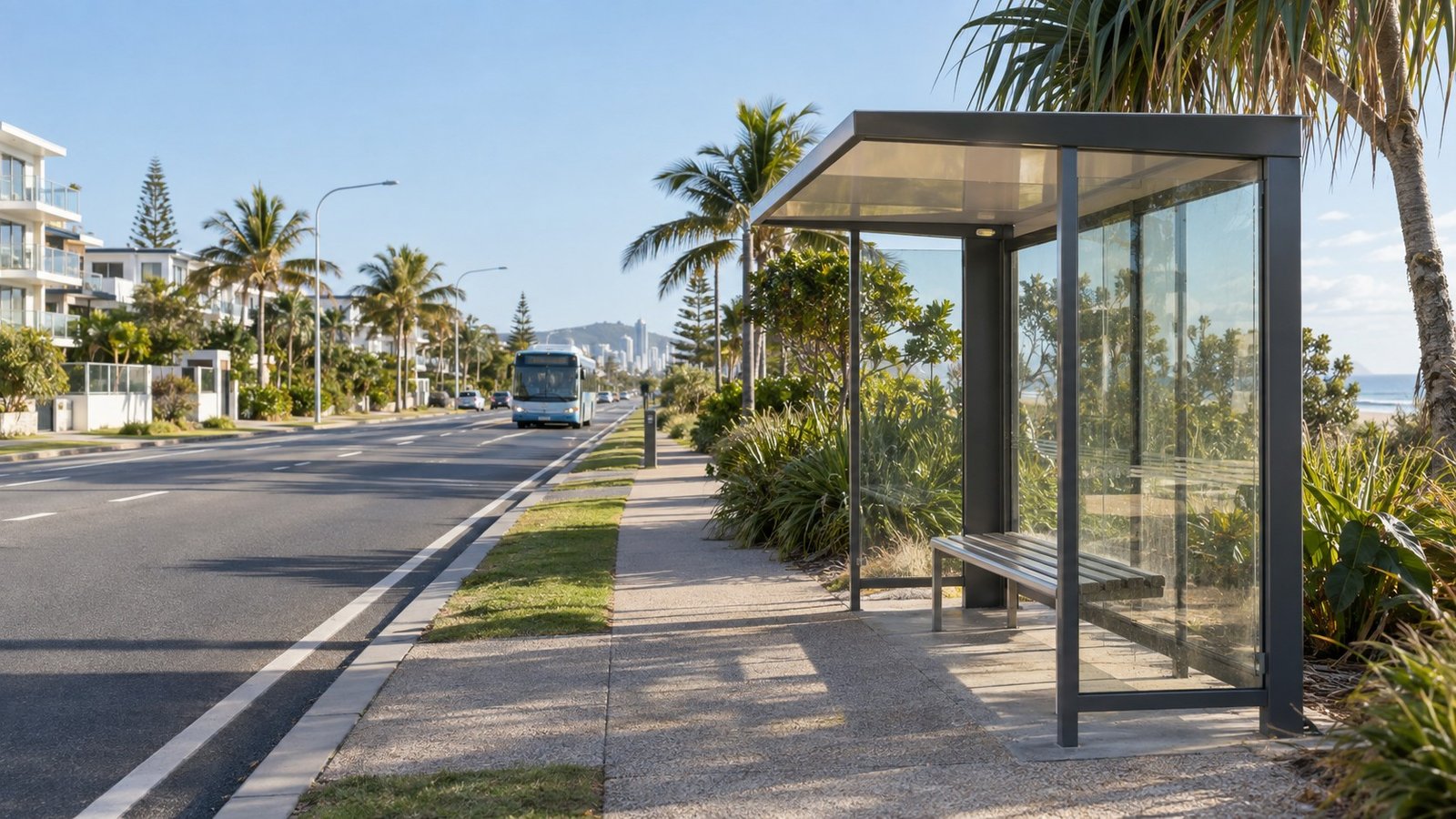Modern bus stop and shelter on a palm-lined arterial road in the southern Gold Coast