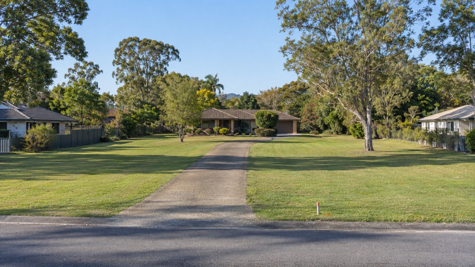 Large suburban block with a wide street frontage and survey markers in the verge